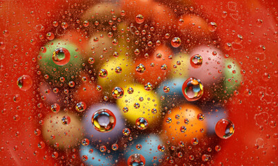 Colorful candy reflections in water droplets.