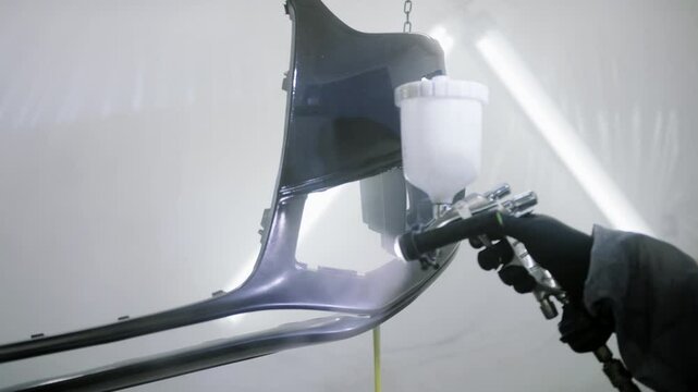 Professional car bumper painting occurs in a spray booth with an intricate process