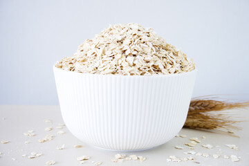 Oat flakes in bowl on a white table