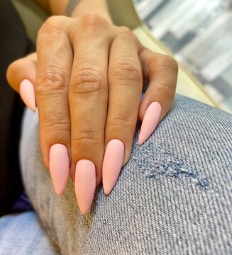 Pink elegant manicure on a woman's hand