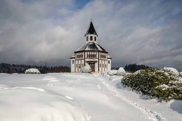 The church in Korenov in the Jizera mountains. Fresh white snow.