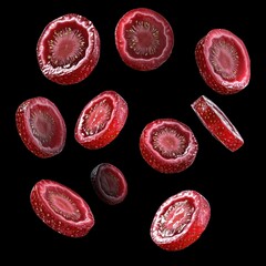 Fototapeta premium Fresh strawberry slices levitating against a black background.