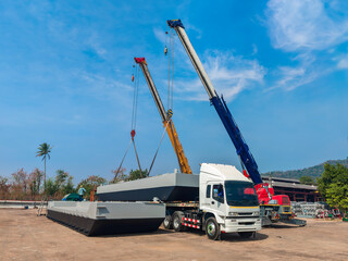 A Mobile Crane Lifts a Barge onto a Trailer for Transport from the Fabrication Shop to the River.
