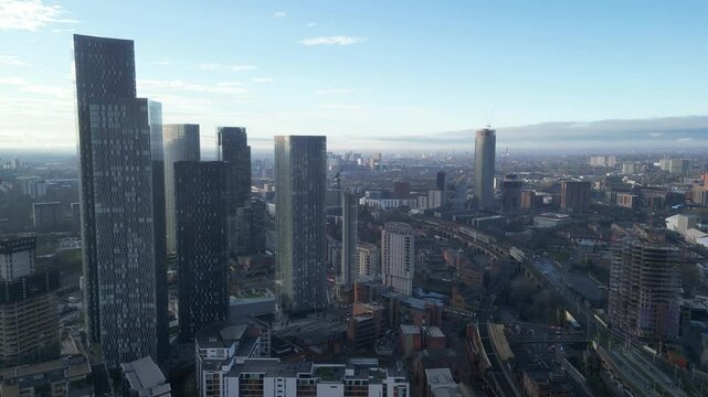 Aerial drone shot across Manchester shot from the west looking east at Deansgate Square, Manchester, UK