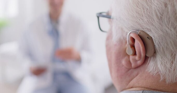 Cochlear implant, senior man ear close up, small electronic device to provide good sense of sound to elder deaf, hard-of-hearing mature enjoying hearing ability after deafness therapy, communication