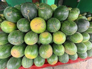 Fresh Watermelons Stacked at Market