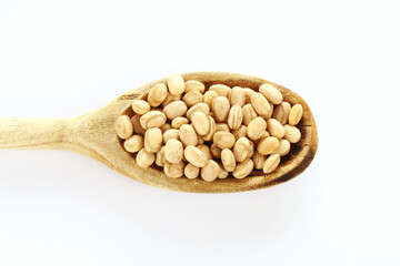 Carioca beans in a wooden spoon on the white background. Brazilian grains.