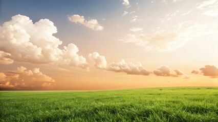 Obraz premium A serene landscape featuring lush green grass under a bright sky with fluffy clouds and a warm sunset in the background.
