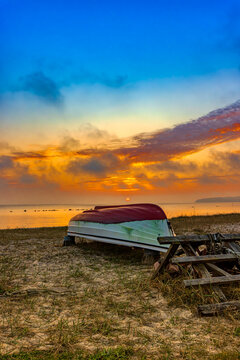 Fishing boat at sunset after a day's work on the beach of a small bay