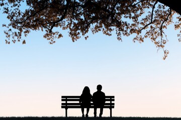 Obraz premium Silhouetted couple sitting on a bench under a tree during sunset, enjoying a serene moment
