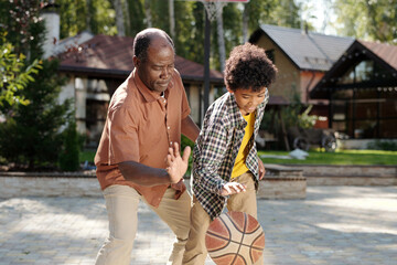 Father Teaching Son Basketball in Backyard Game