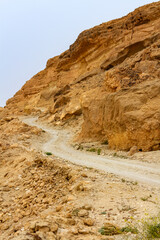 A dirt road in the mountains. A section of a road built by German troops during World War II. Kasserine Pass. Tunisian mountains.  Tunisia, Africa