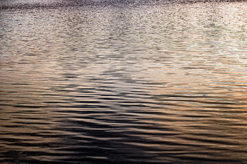 Sunset reflection on lake surface, water background