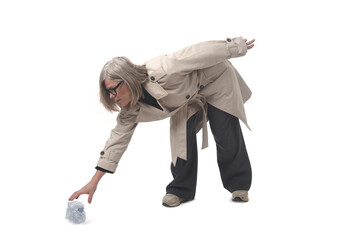  view of a woman picking up a plastic water bottle on the floor on white background