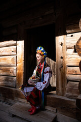 Obraz premium Woman in traditional costume. Ukrainian woman with a basket of apples. A young woman in a national Ukrainian costume. Embroidery. Ukrainian national clothing.