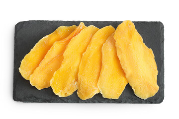 dried mango on a black stone board isolated on white background. Top view. Flat lay