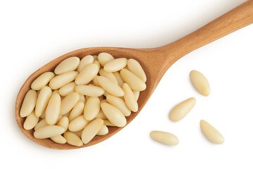 Shelled European pine nuts in wooden spoon isolated on white background with full depth of field....