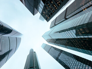 A city skyline with tall buildings and a cloudy sky