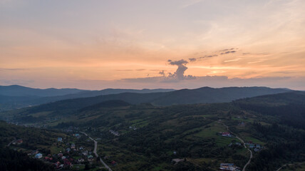 Aerial View Of Majestic Mountains Shrouded In Clouds And Mist, Overlooking Expansive Agricultural...