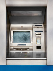 Vertical image a broken ATM on a city street with a broken screen.