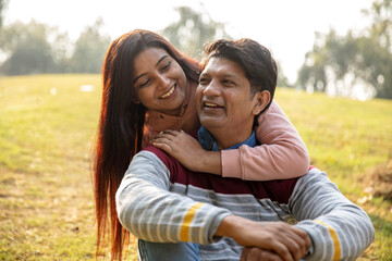 Naklejka premium Indian young romantic couple hugging at outdoor. Lovely couple embracing each other at park