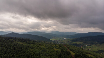 Majestic Mountains, Lush Green Forests, And Dramatic Clouds With The Sun Casting A Golden Glow. Aerial View Capturing The Stunning Beauty Of Nature From A Bird&rsquo;s-Eye Perspective.