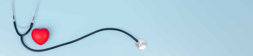 Stethoscope and red hearts on light blue background, Health care concept,  World heart health day,...