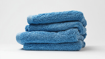 Stacked Soft Fluffy Blue Towels on White Background