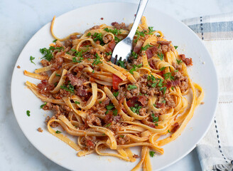 linquine  top with crumble  sausage, bacon  bits and parsley