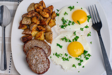 fried eggs top with parsley  with sausage patty