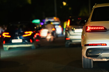 Urban Traffic Scene at Night Featuring Cars in Motion in Low Light