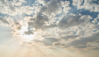 Obraz premium Radiant sunlight breaking through fluffy clouds, nature's beauty