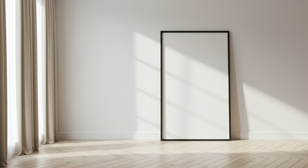 A bright modern minimalist interior featuring a large black framed blank poster leaning against a pristine white wall