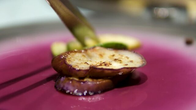 Grilled eggplant zucchini slices pieces in balsamic vinegar sauce, basil leaf herb on white plate Sardinian traditional dish in Sardinia macro closeup