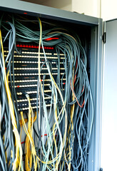Switchboard panel with chaotic mess  cables connections, Chaos In Server Room, The tangled network cable, vintage, with white tones