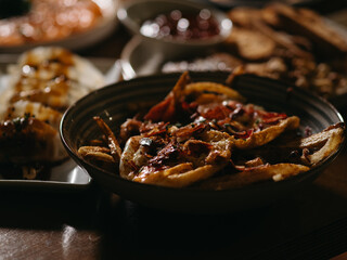 Fries with ham and eggs in the table