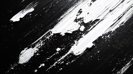 Dynamic white paint strokes forming diagonal lines across deep black surface, generating stark geometric abstract design