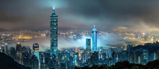 Fototapeta premium Night in Hong Kong: City Skyline Enveloped in Fog