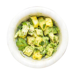Yellow and green colored sliced fruits in a white ceramic bowl