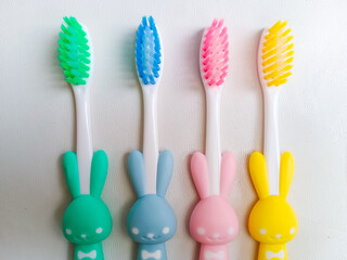 Close up of colorful kid tooth brush on white background. Cute bunny tooth brush for children on white background