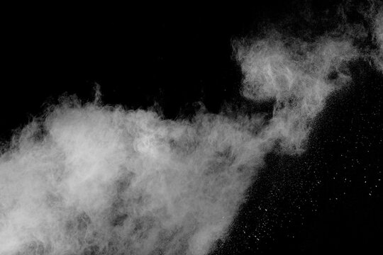 Black and white photo of a cloud of white powder