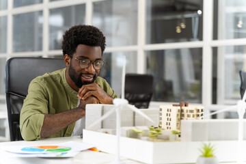 Young male architect looking at the new living area mock up and feeling contented