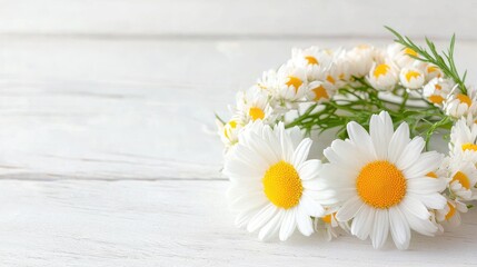 Obraz premium Delicate white daisy flower wreath lying on a rustic white wooden table in bright natural light.