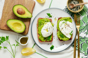 Whole grain toast with avocado and poached egg. for breakfast  .Healthy appetizer.