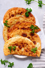 Chebureki  on white plate.style hugge. top veiw