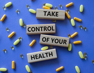 Health symbol. Concept word Take Control of your Health on wooden blocks. Beautiful purple...