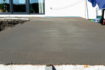 Pouring handmade concrete on to a home terrace covered with reinforcement.