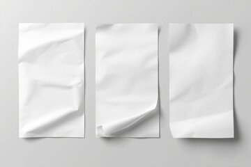 Three sheets of crumpled white paper arranged side by side on a gray background