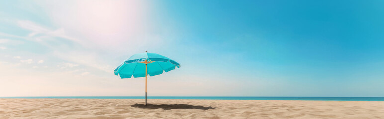 Obraz premium Beach umbrella on sandy beach under clear blue sky, summertime relaxation background
