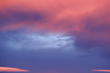 Pastel sunset hues paint the sky with soft pink and purple clouds